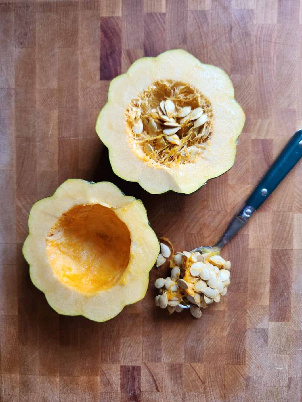 Acorn squash opened with seeds scooped out.