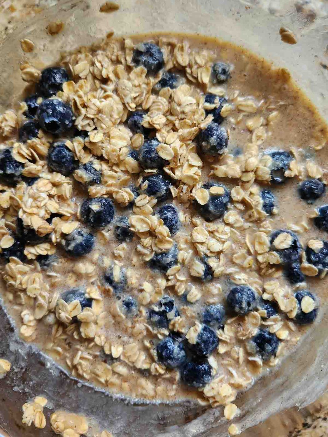 Overhead of baked oatmeal batter in a bowl.