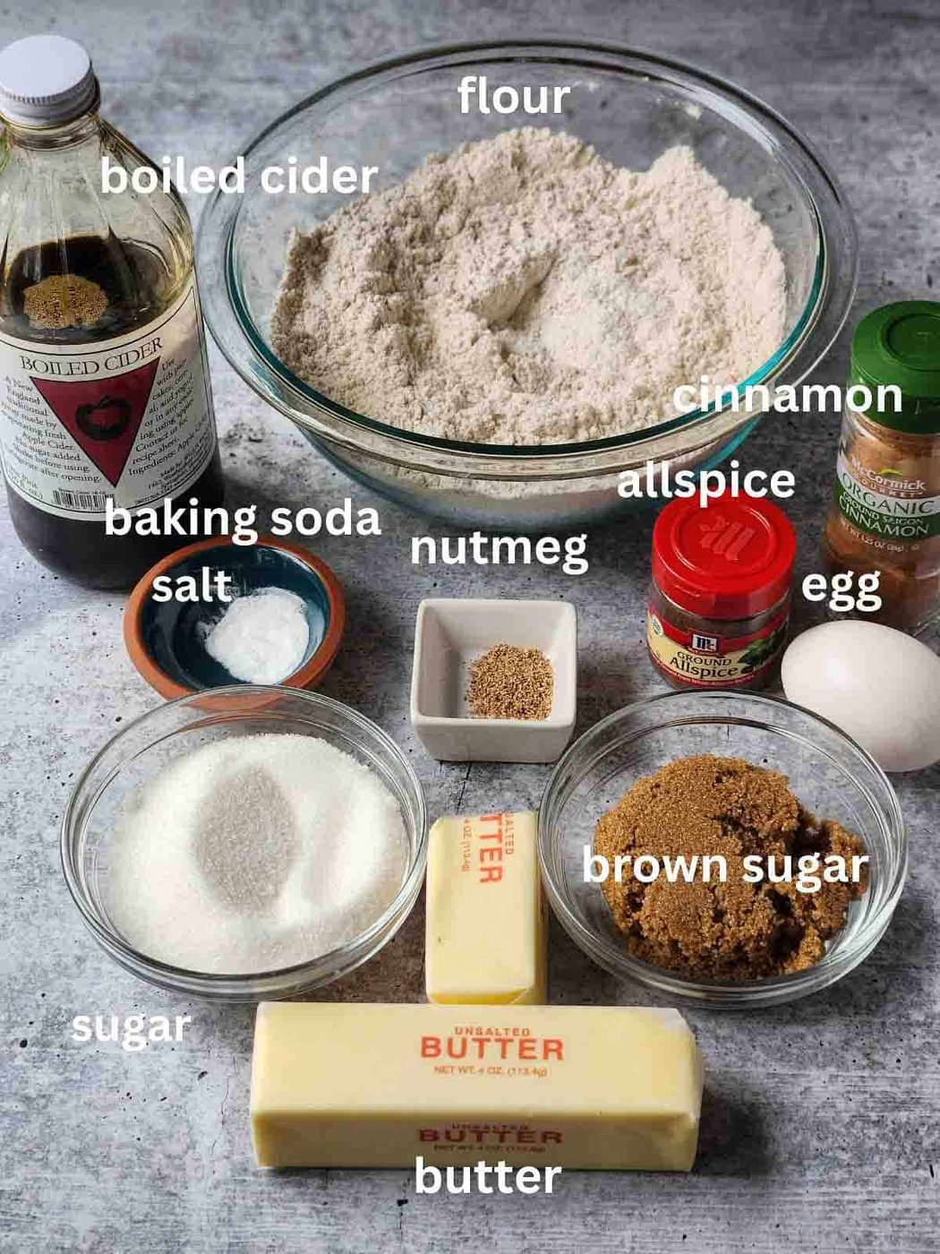 Ingredients for apple cider cookies an a grey surface.