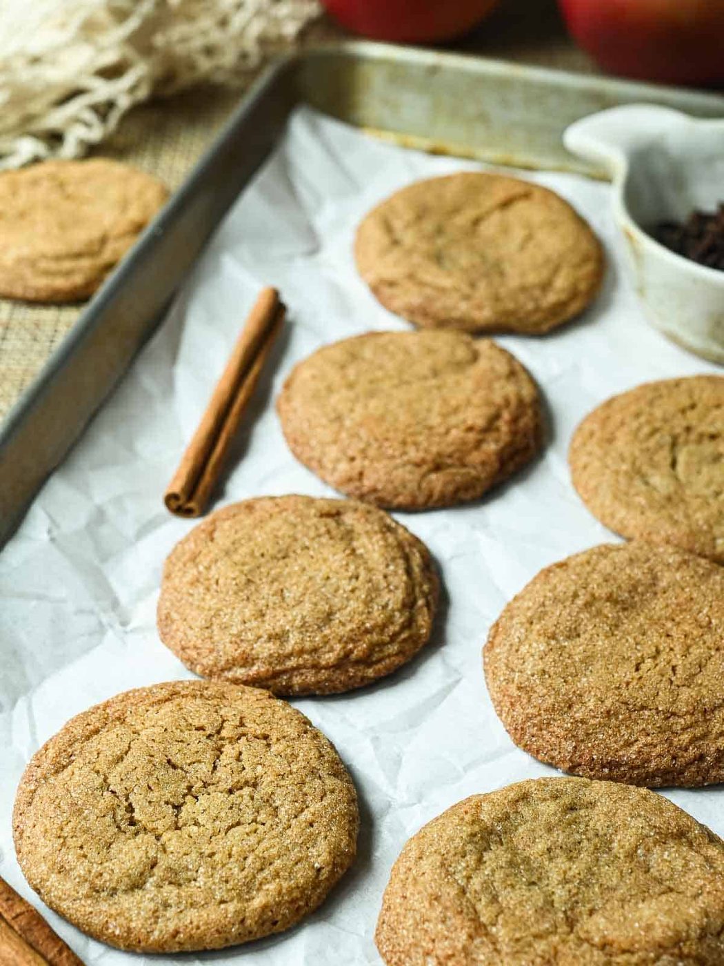 Apple cider cookies on a baking tray with parchment paper.