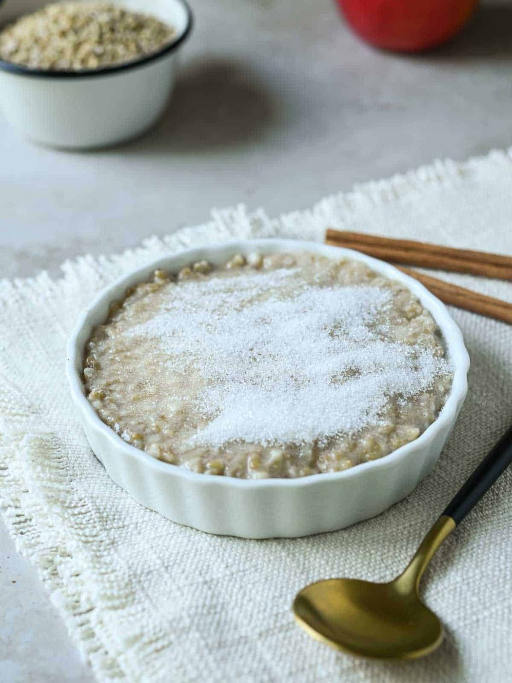 White sugar on top of a dish of oatmeal.