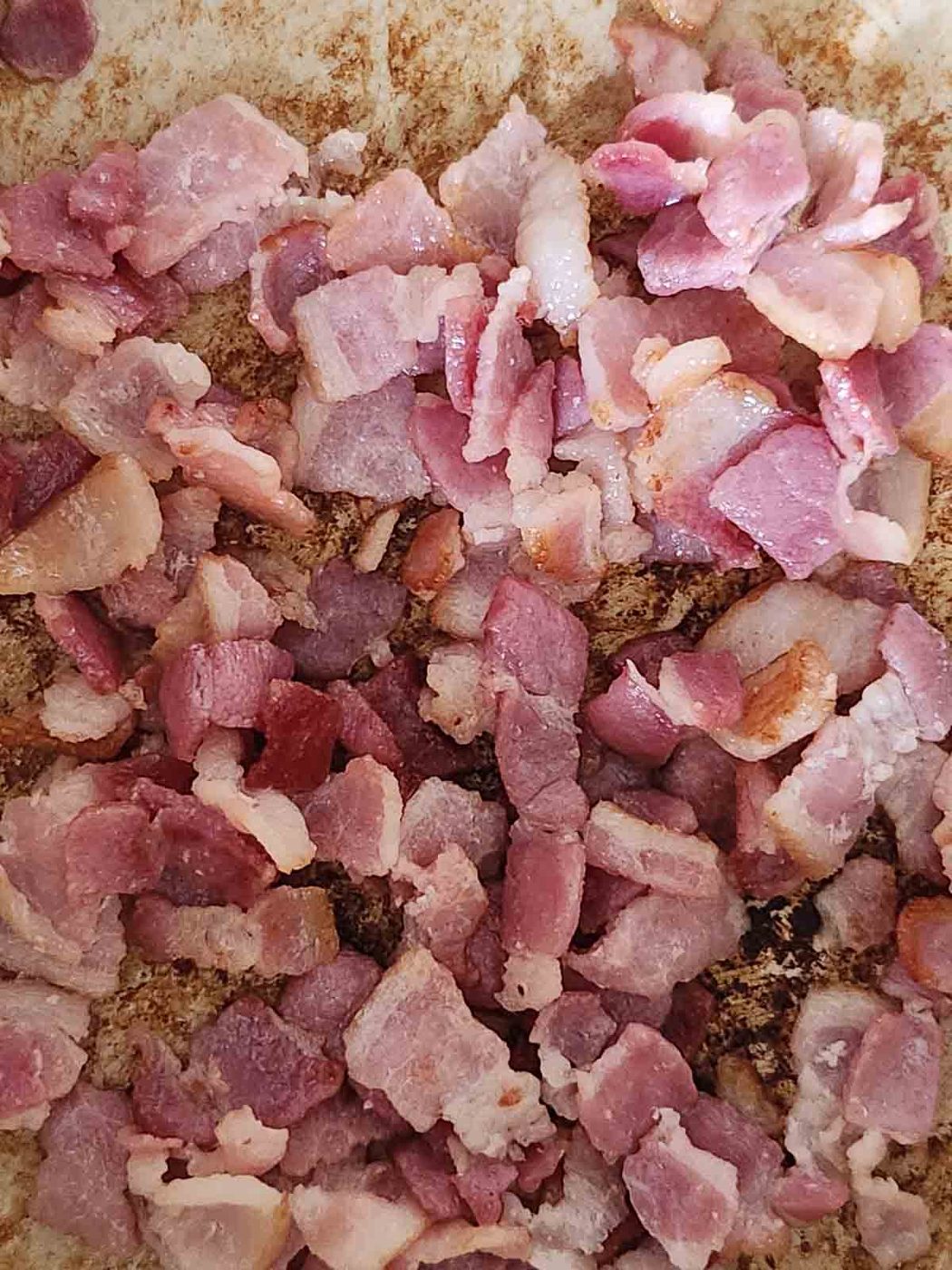 Bacon browning in a pan.