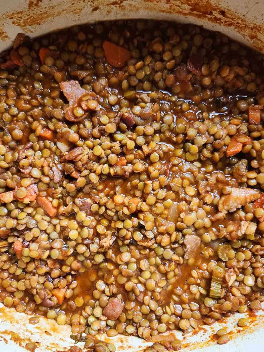 Overhead of bacon lentil soup in a pot.