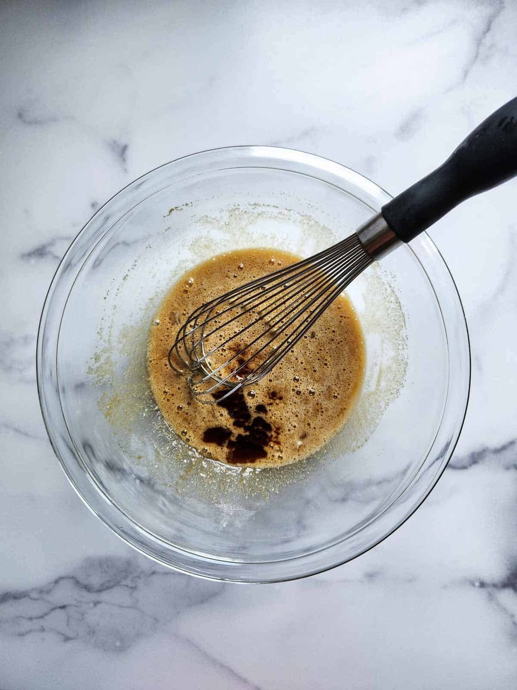 Whisking wet ingredients in a bowl.