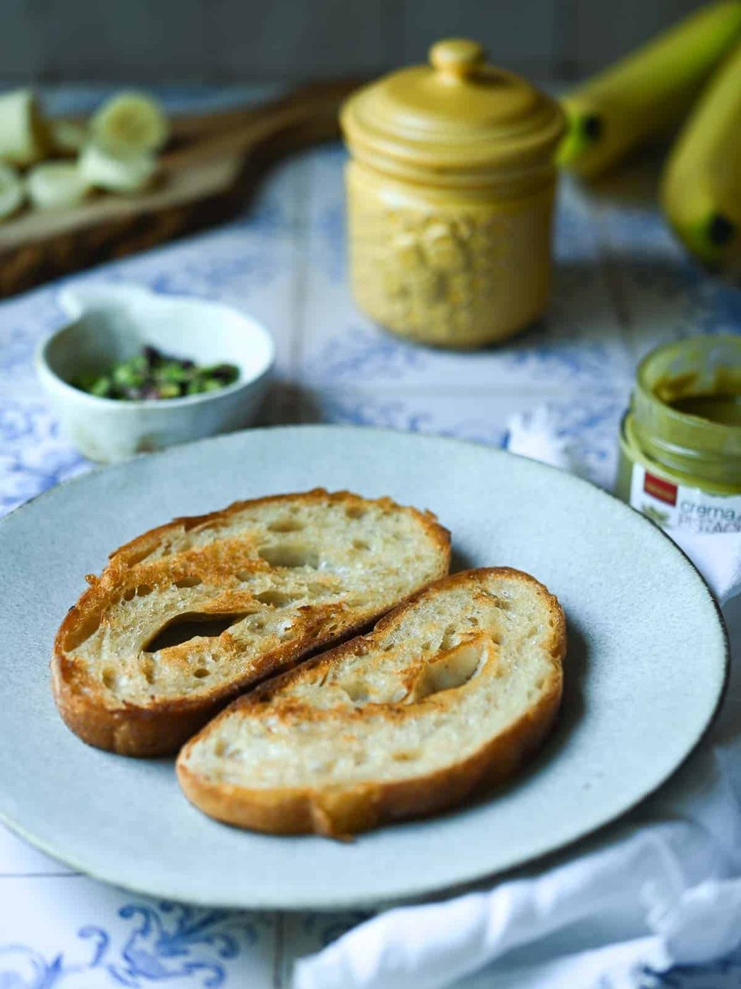 Two slices of bread on a white plate.