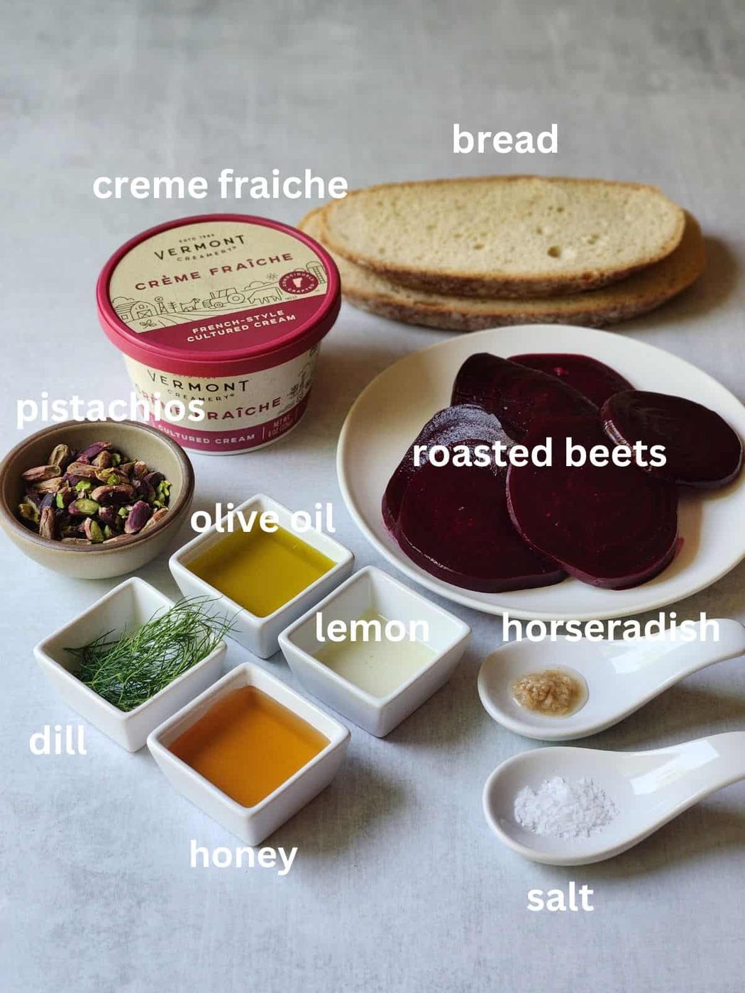 Beet toast ingredients on a grey surface.
