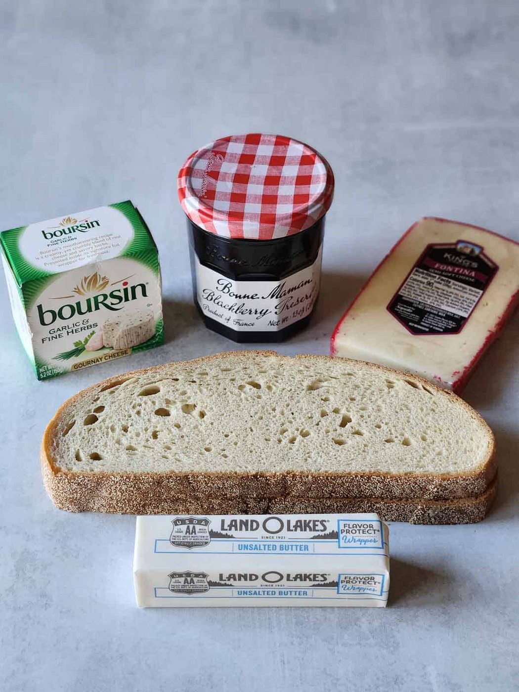 Ingredients for blackberry Boursin grilled cheese on a grey surface.