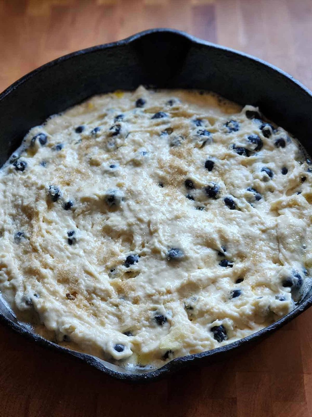 Pancake batter in a cast iron skillet.