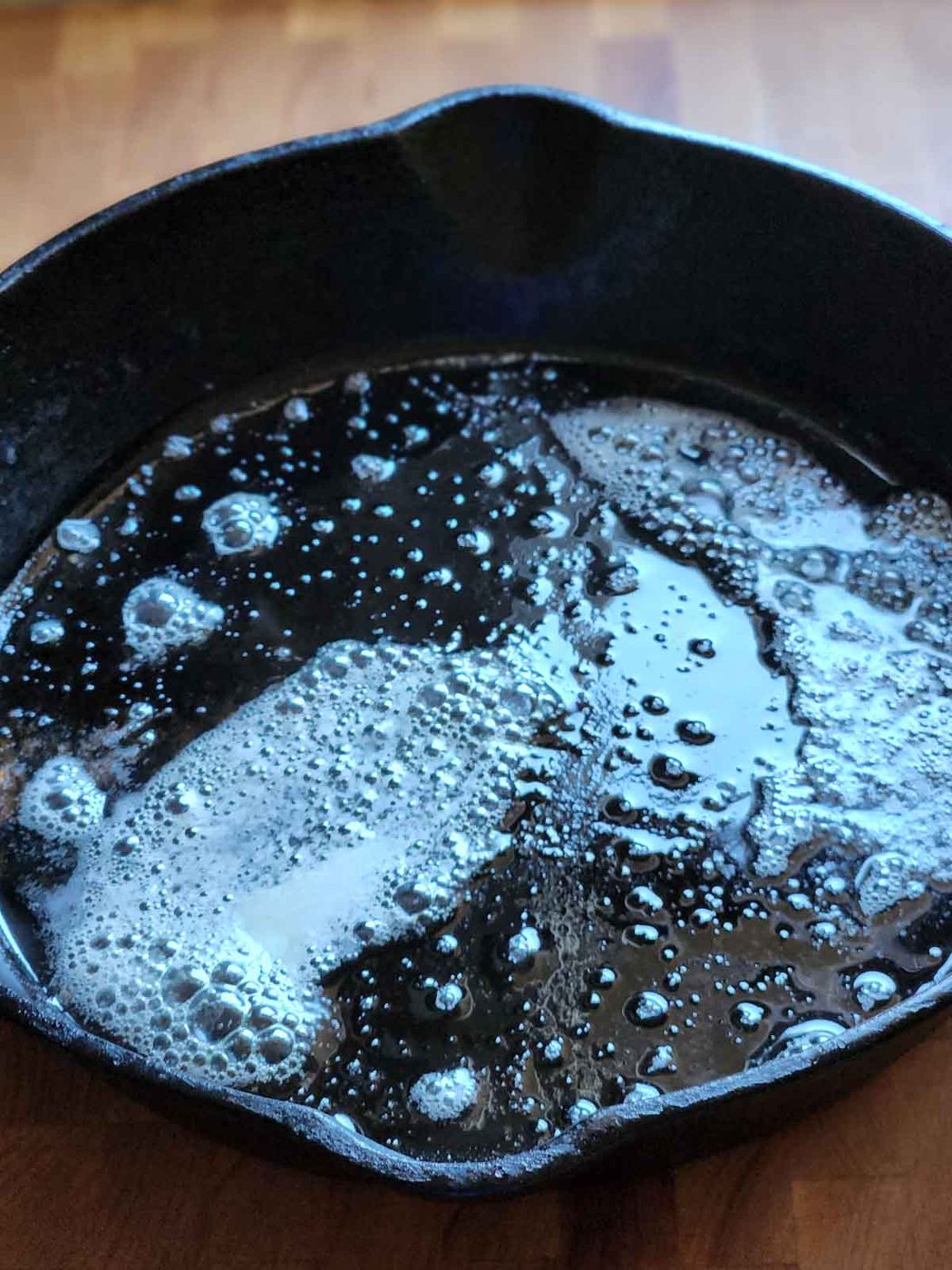 Melted butter in a black skillet.