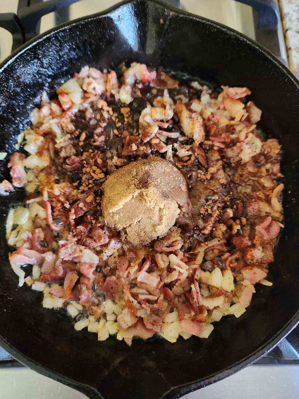 Ingredients for bourbon bacon chutney in a cast iron skillet.