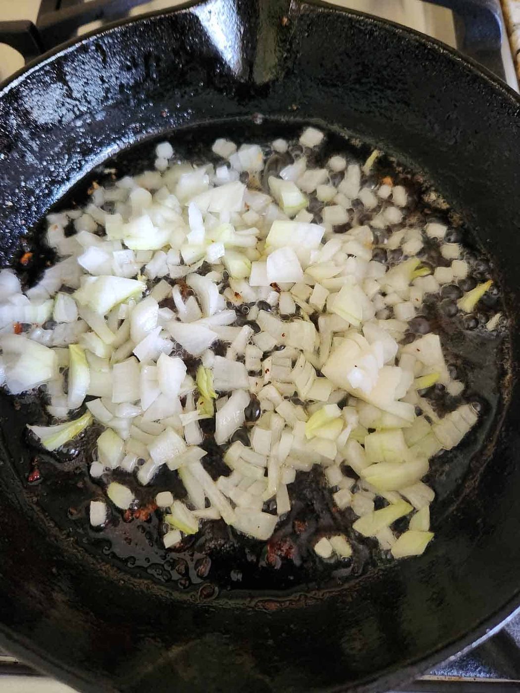 Sautéed onions in a black cast iron skillet.
