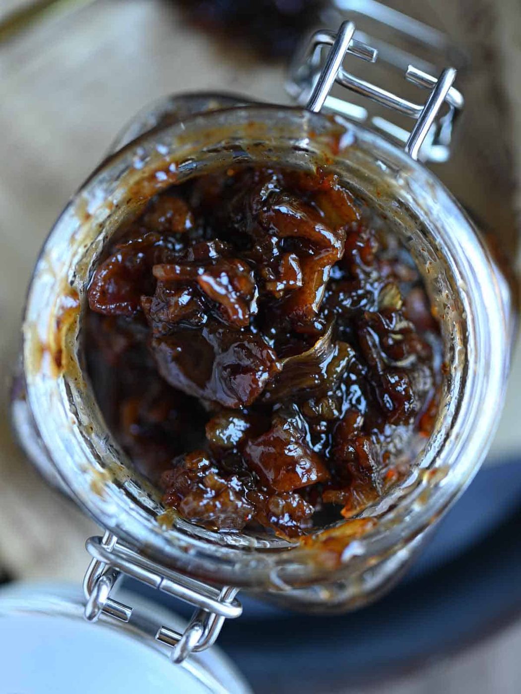 Overhead of bacon bourbon jam in a glass jar.