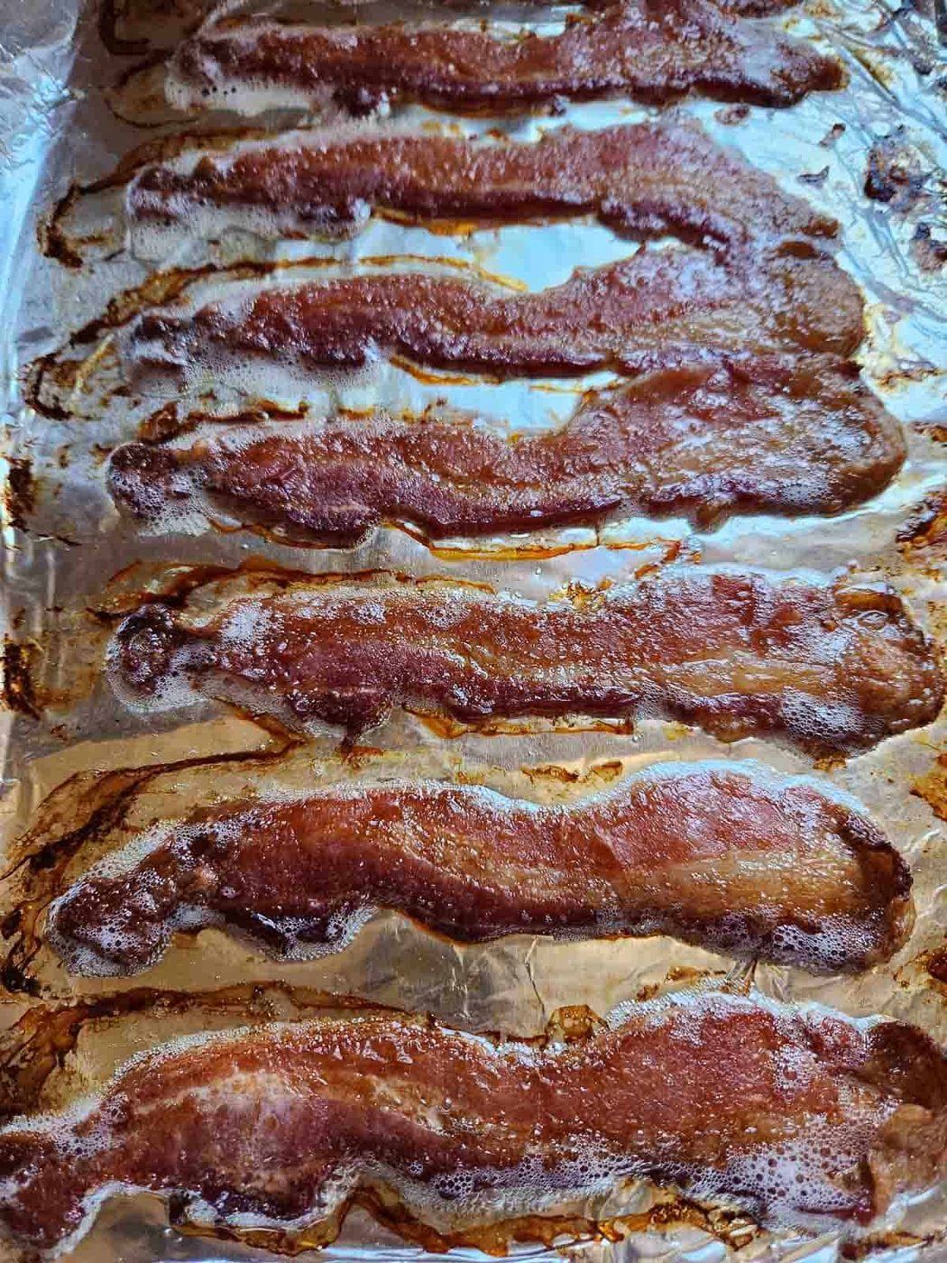 Cooked bacon on a sheet pan.
