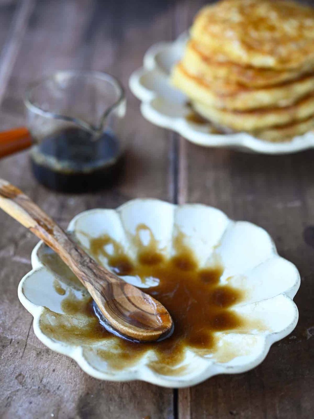 Brown sugar syrup in a beige flower shaped bowl.