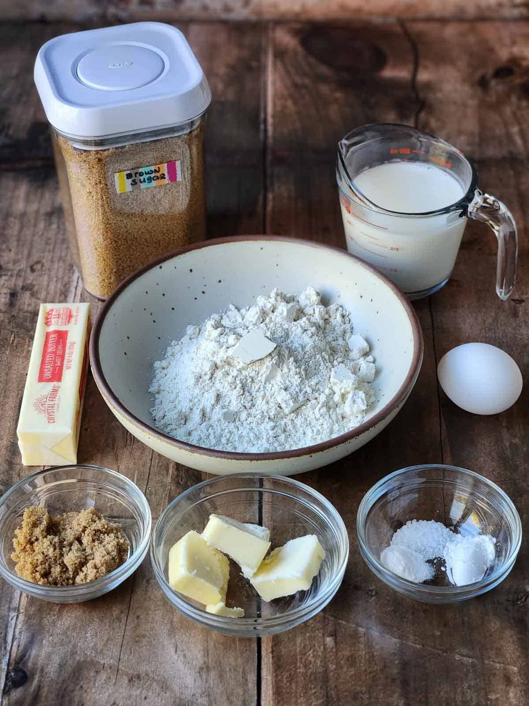 Ingredients for brown sugar pancakes on a wood surface.