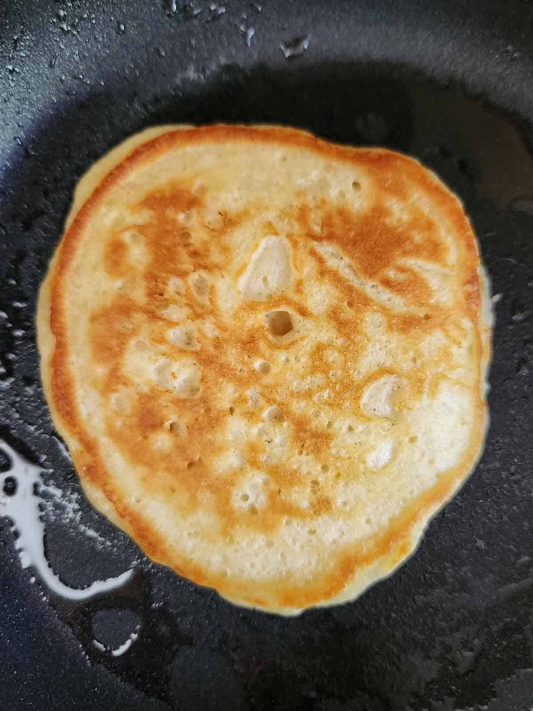 Brown sugar pancake cooked on a griddle.