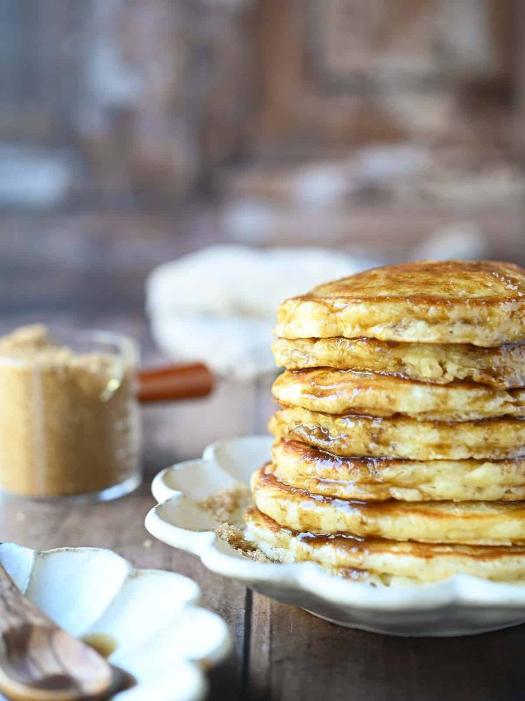 Eye-level view of a pancake stack with brown sugar.