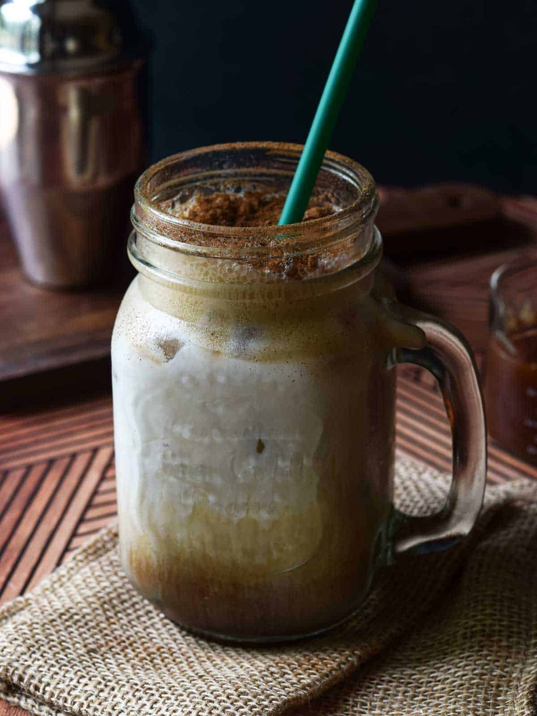 Close-up brown sugar shaken chai drink in a glass mug.