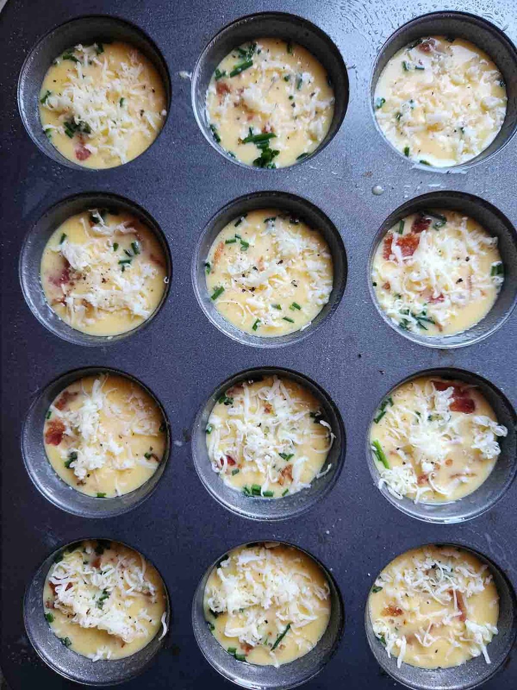 Egg bite batter in a muffin tin.