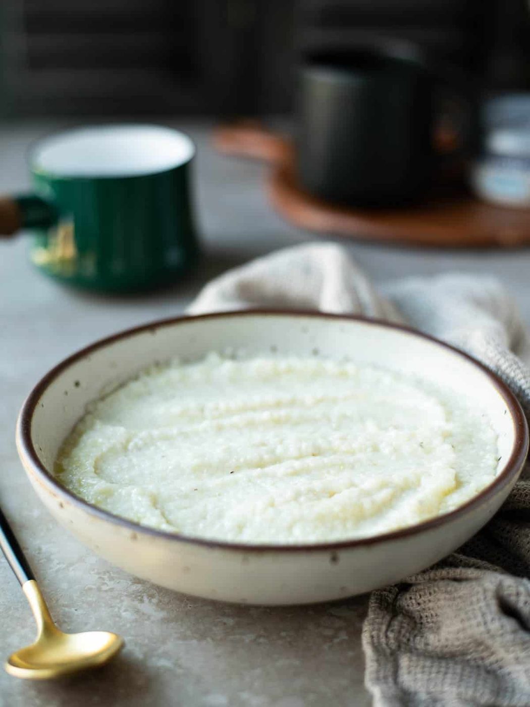 Cream cheese grits in a beige bowl.