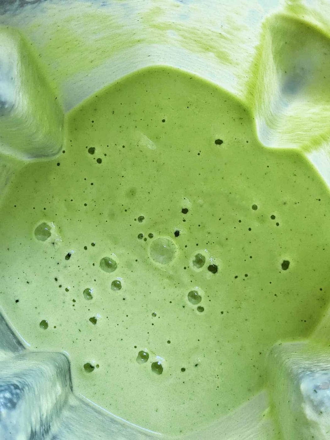 Overhead of cucumber soup blended in a blender.