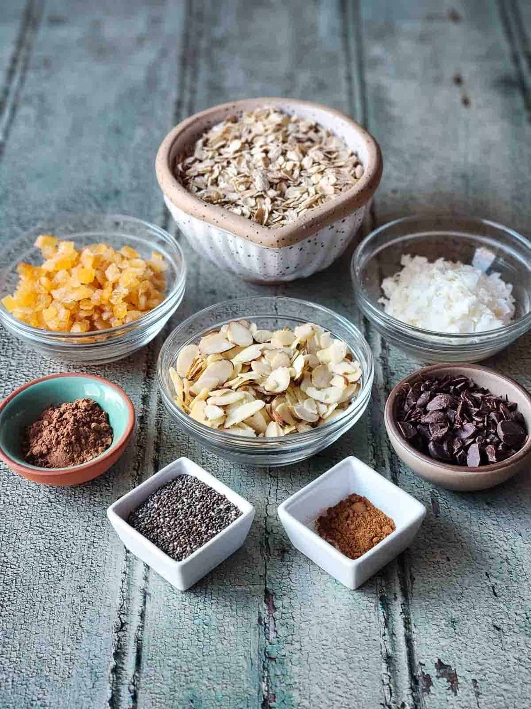 Ingredients for chocolate muesli on a wood board.