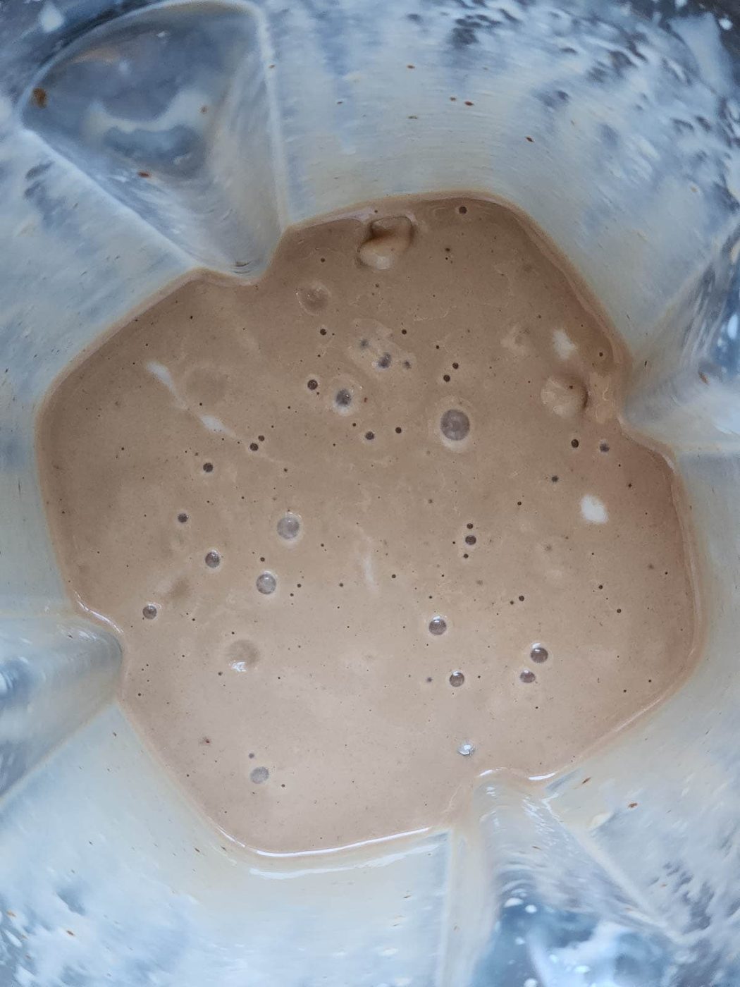 Chocolate tahini smoothie in a blender.