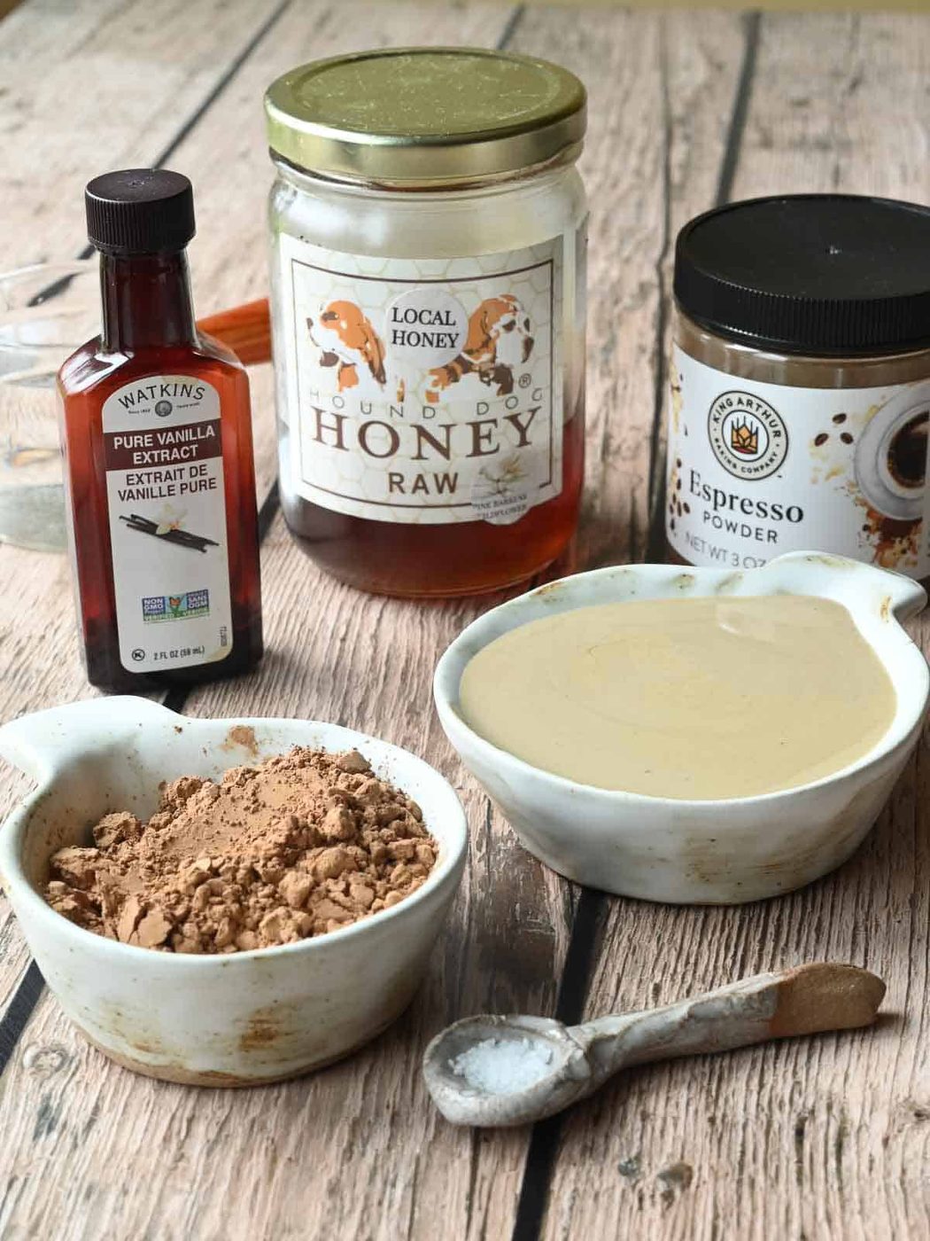 Ingredients for chocolate tahini spread on wood.