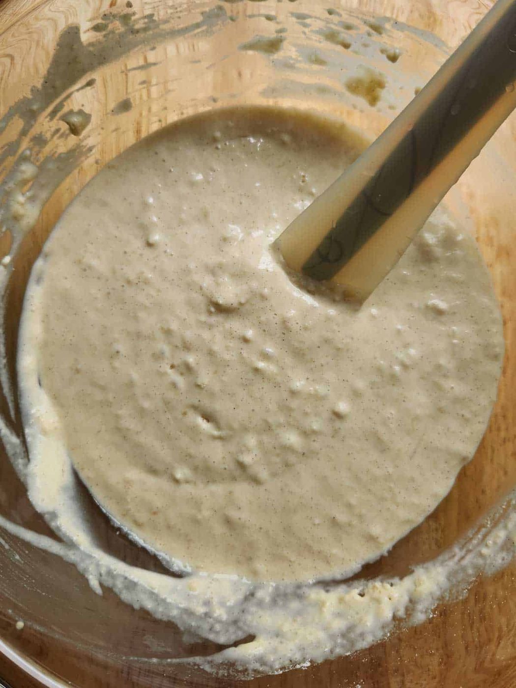 Batter for sweet cream pancakes in a clear bowl.