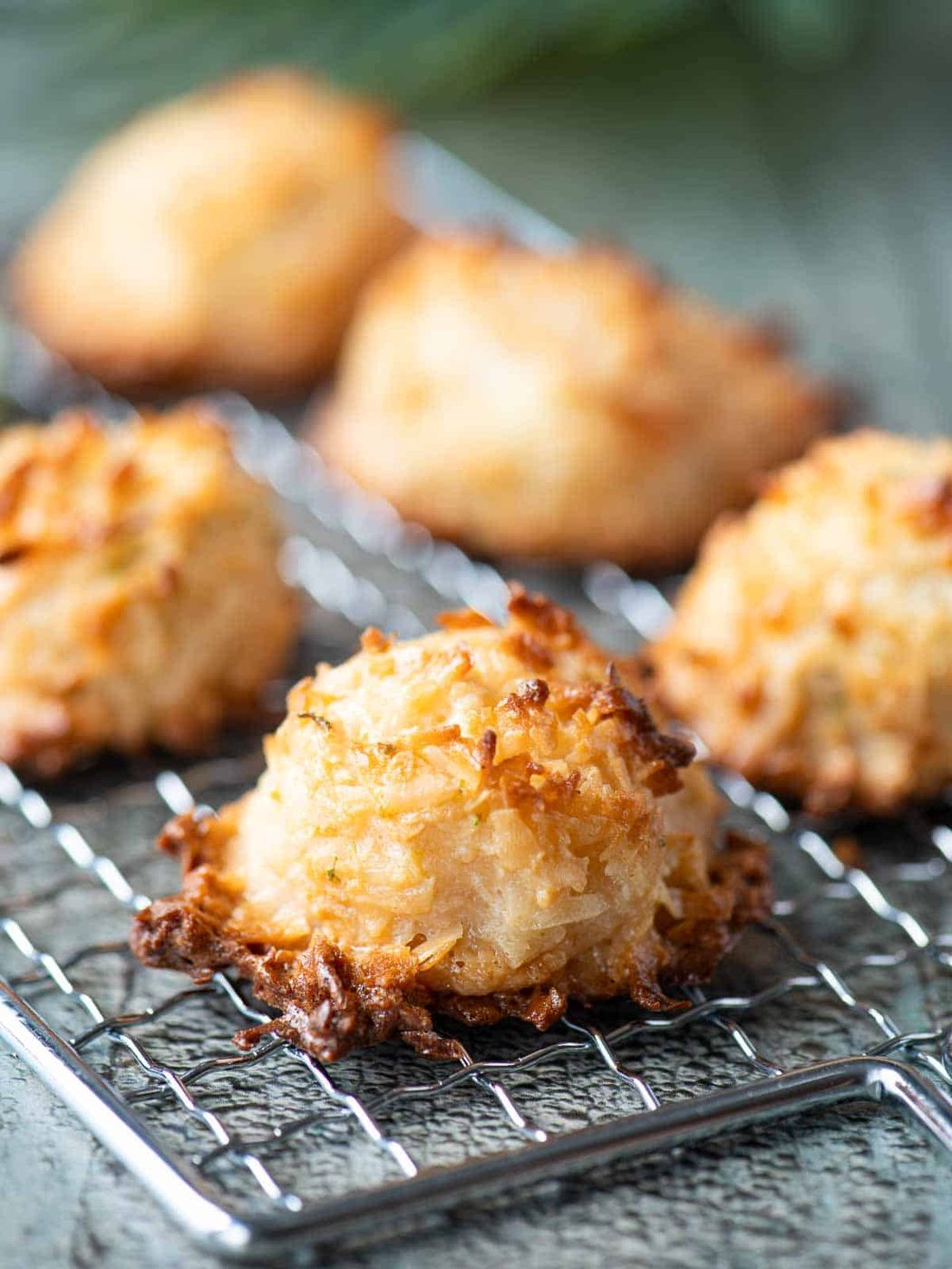 Close up of a coconut macaroon on a wire rack.