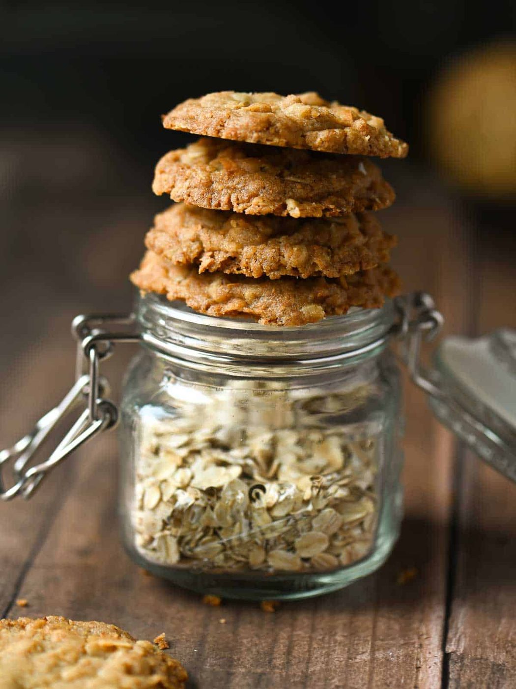 Cookies stacked on a jar of oatmeal.