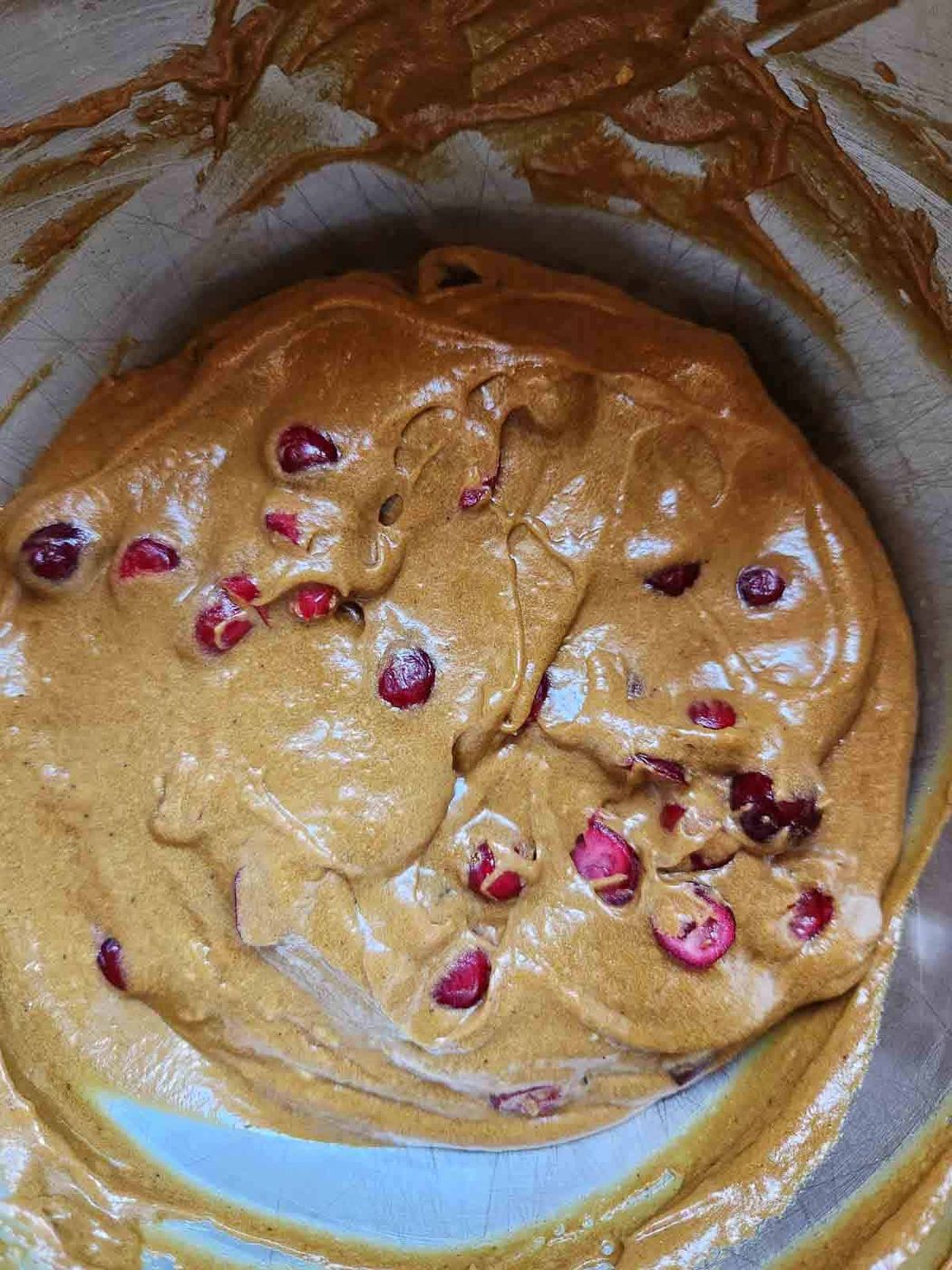 Final batter for cranberry loaf in a metal bowl.