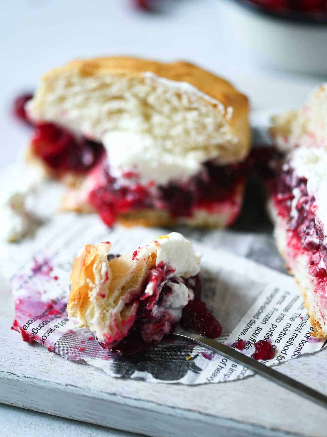 Cranberry shortcake split in half with a bite on a fork.