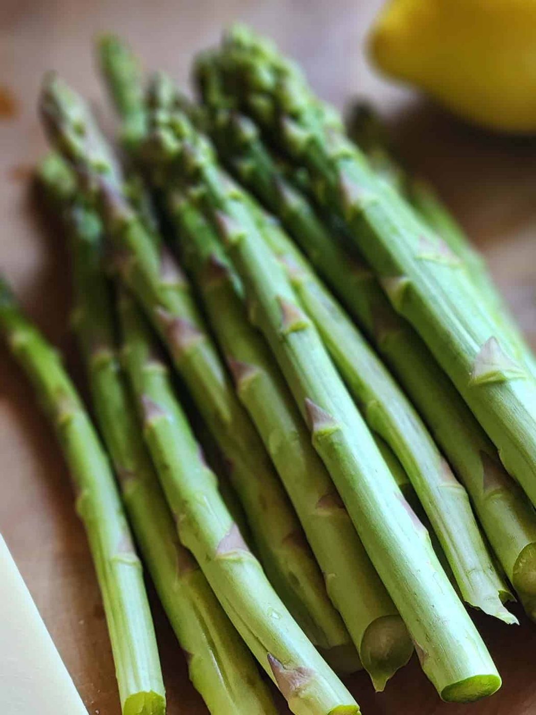 Asparagus spears on a wood board.