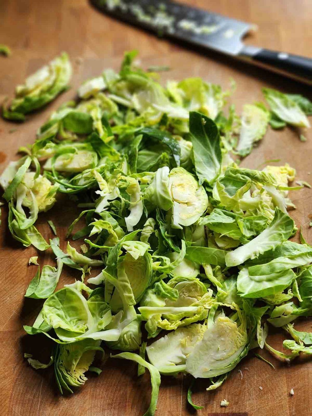 Shredded Brussel sprouts n a cutting board.