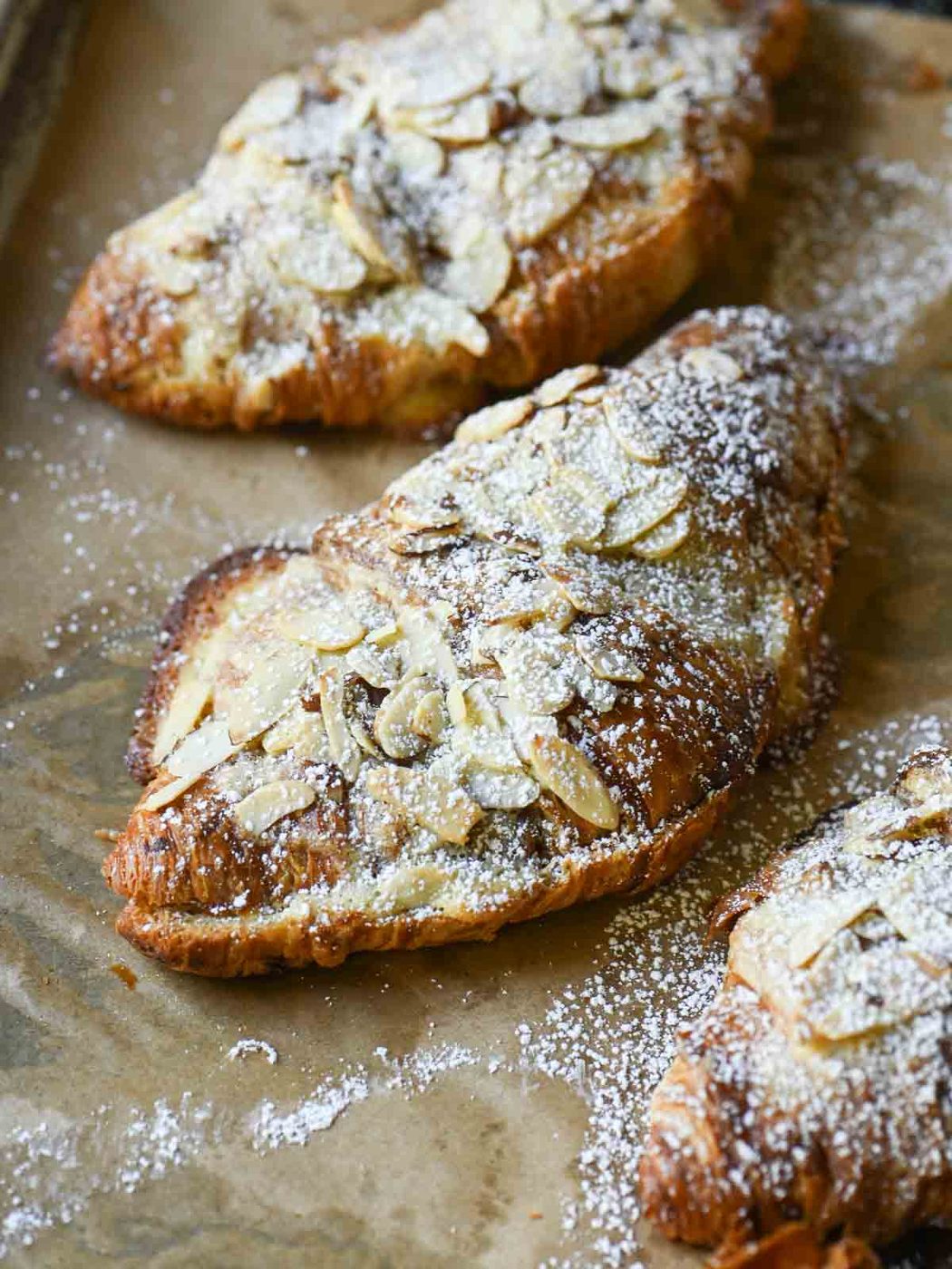 Angled view of the tops of almond croissants.