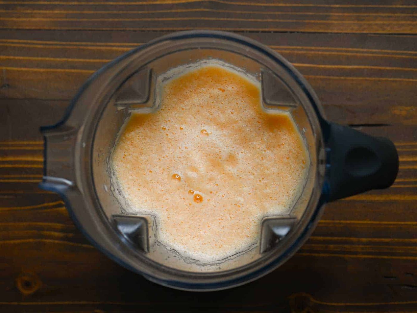 Overhead of blended cantaloupe drink in a blender.