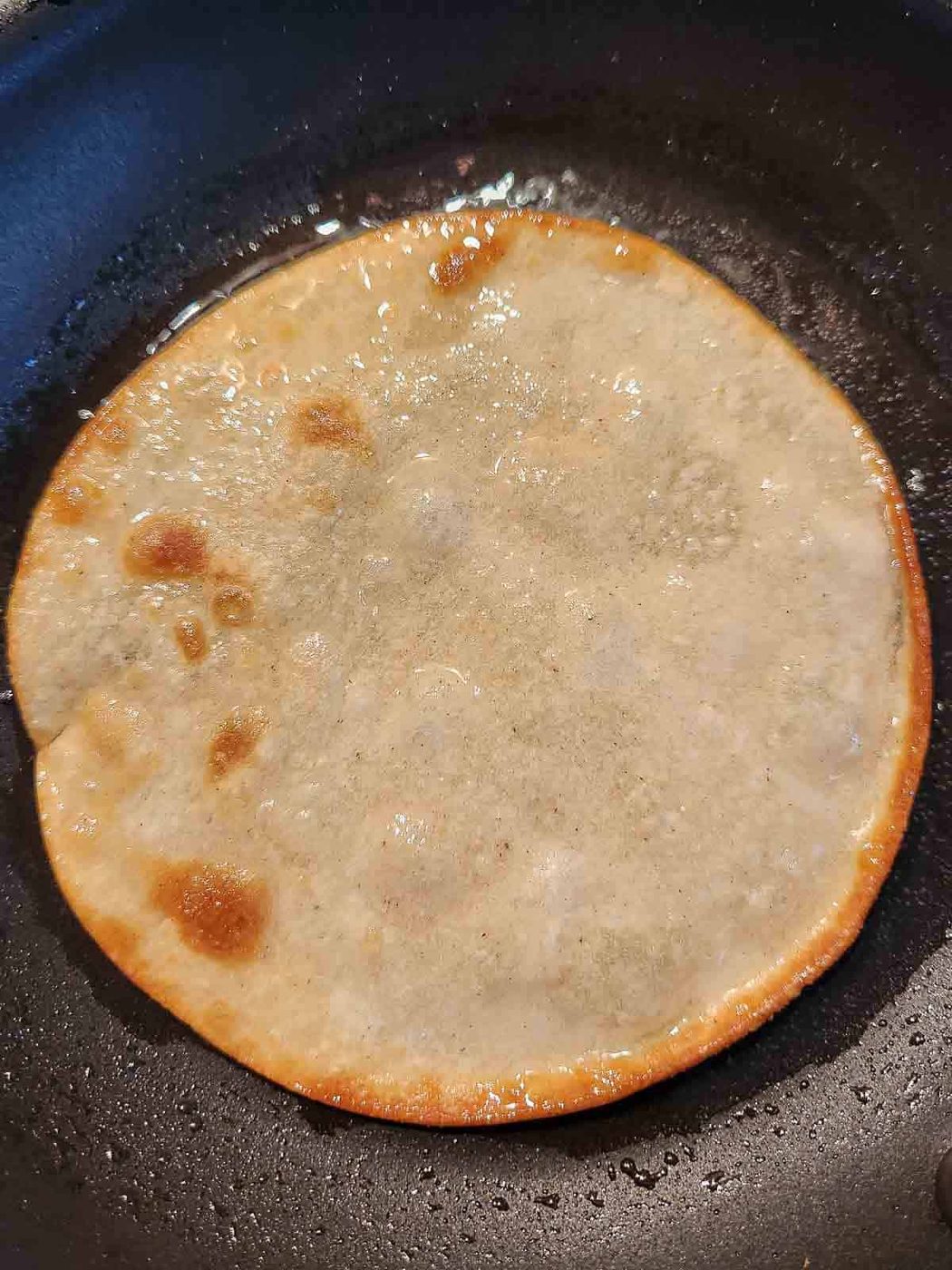 Corn tortilla fried in oil.