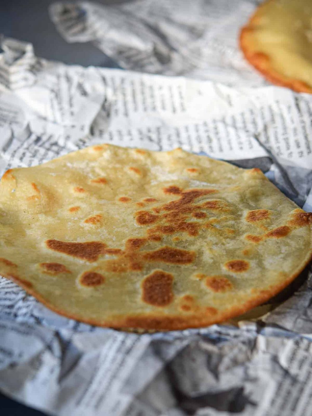 Fried tostada on a newspaper.