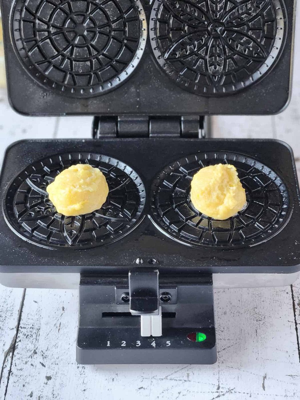 Batter on a pizzelle maker for lemon pizzelles.