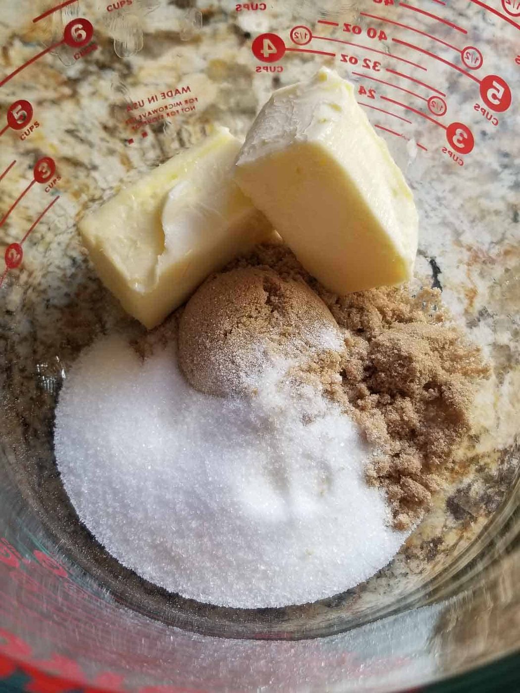 Butter, and sugar in a bowl ready to be mixed for a summer plum cake.