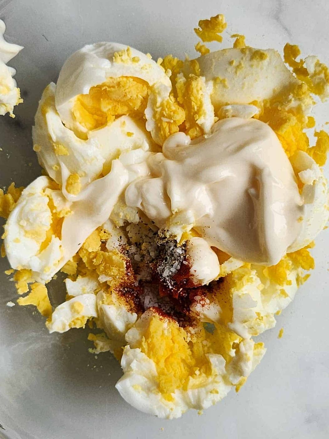 Chopped eggs with mayo, and spices for egg salad.