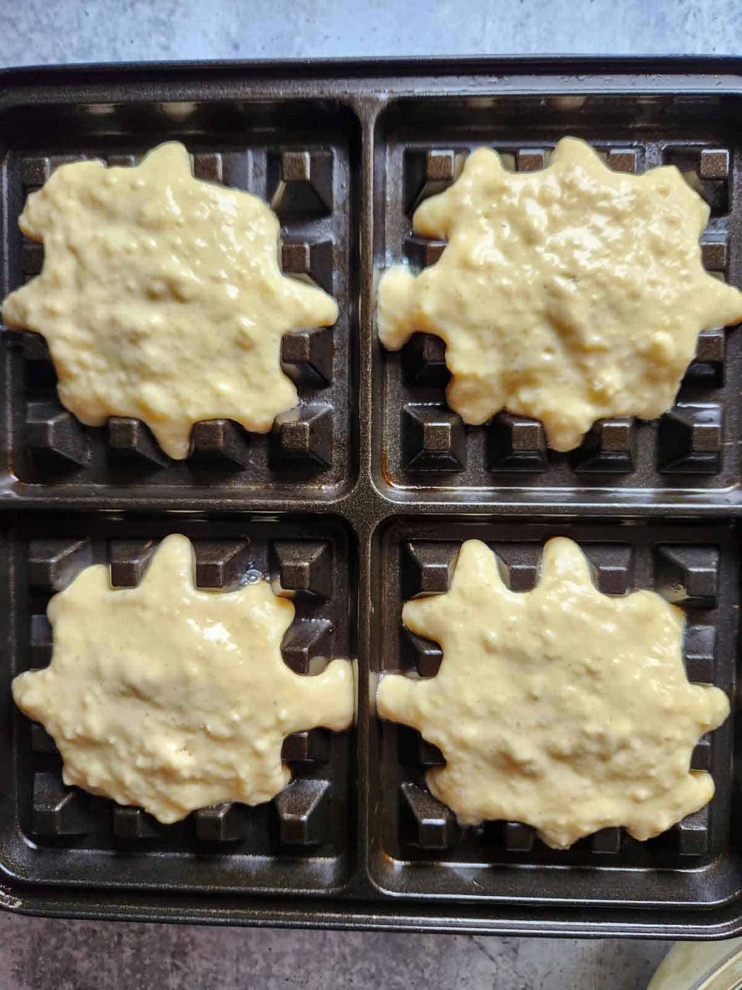 Batter placed on a waffle iron.