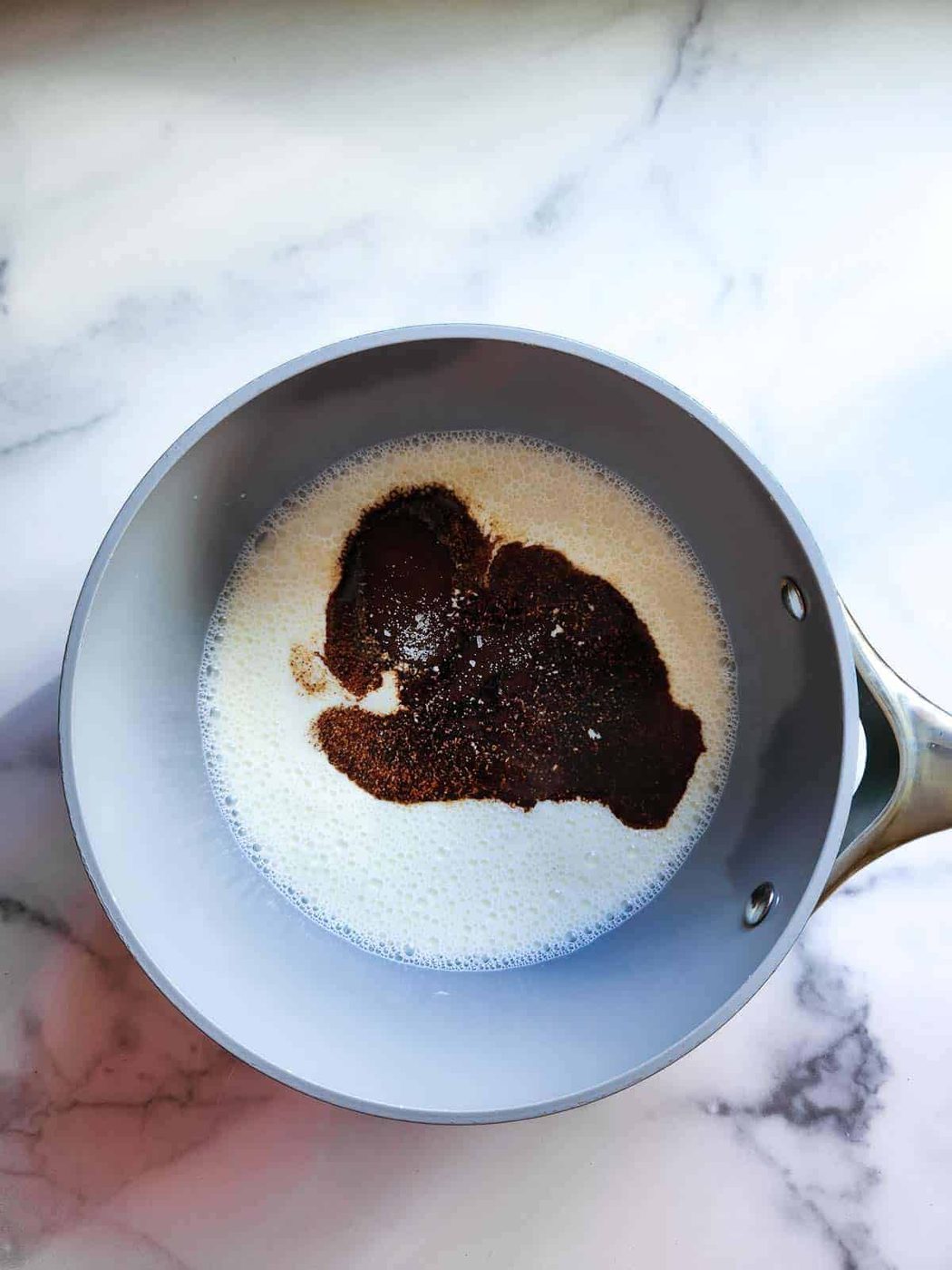 Prepared ingredients in a pot for espresso panna cotta.