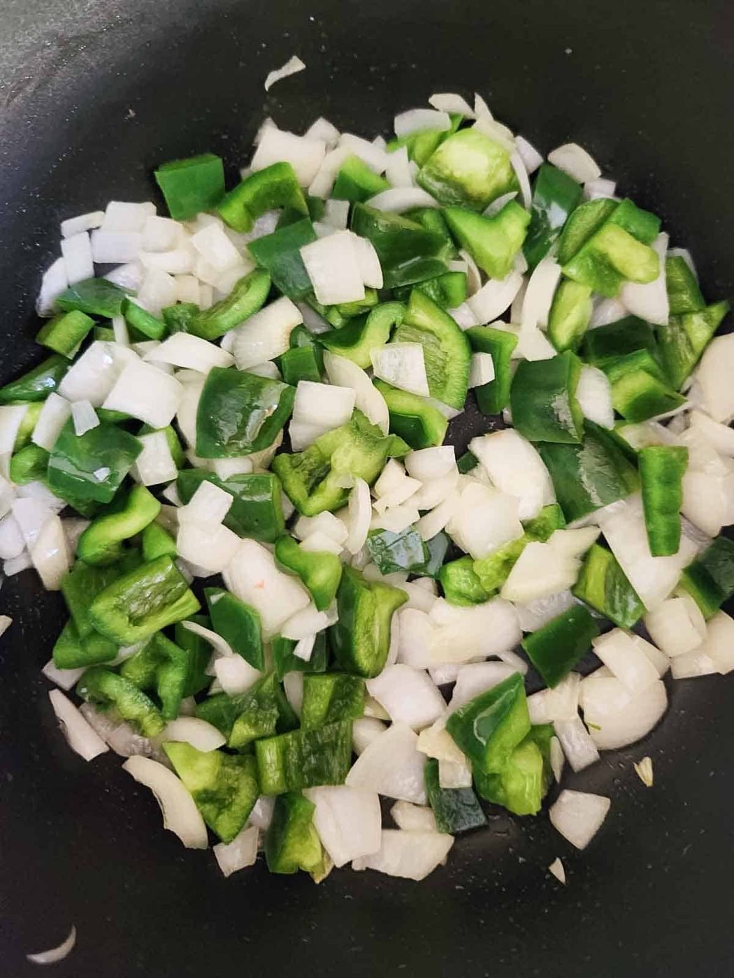 Peppers and onions in a pan.