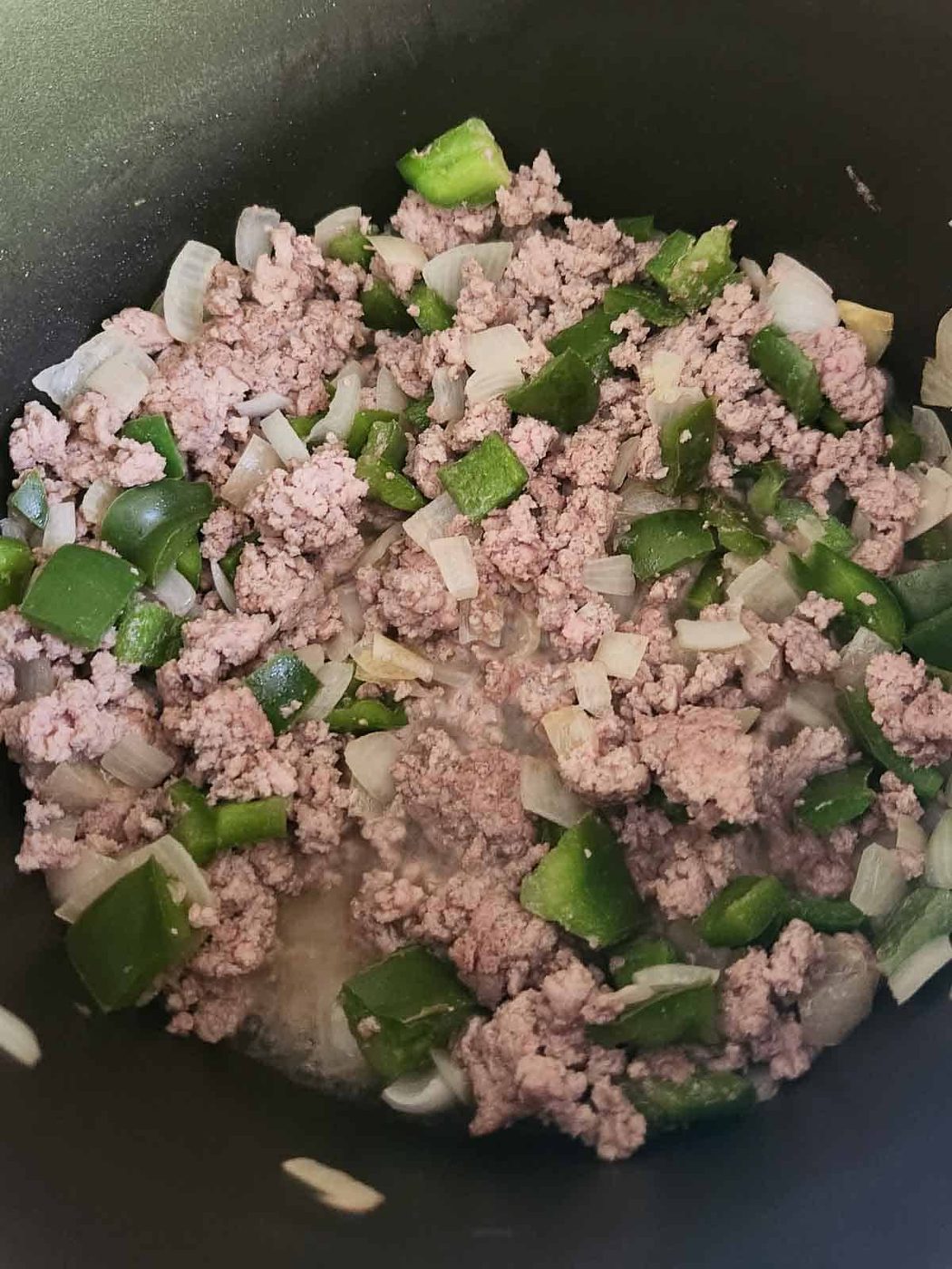 Turkey and vegetables in a pan.