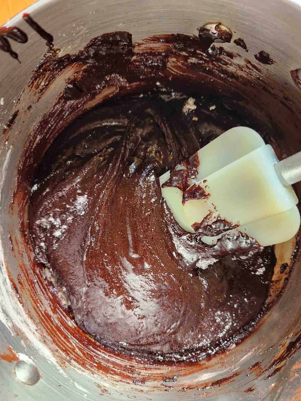 Smooth brownie batter in a bowl with a spatula.