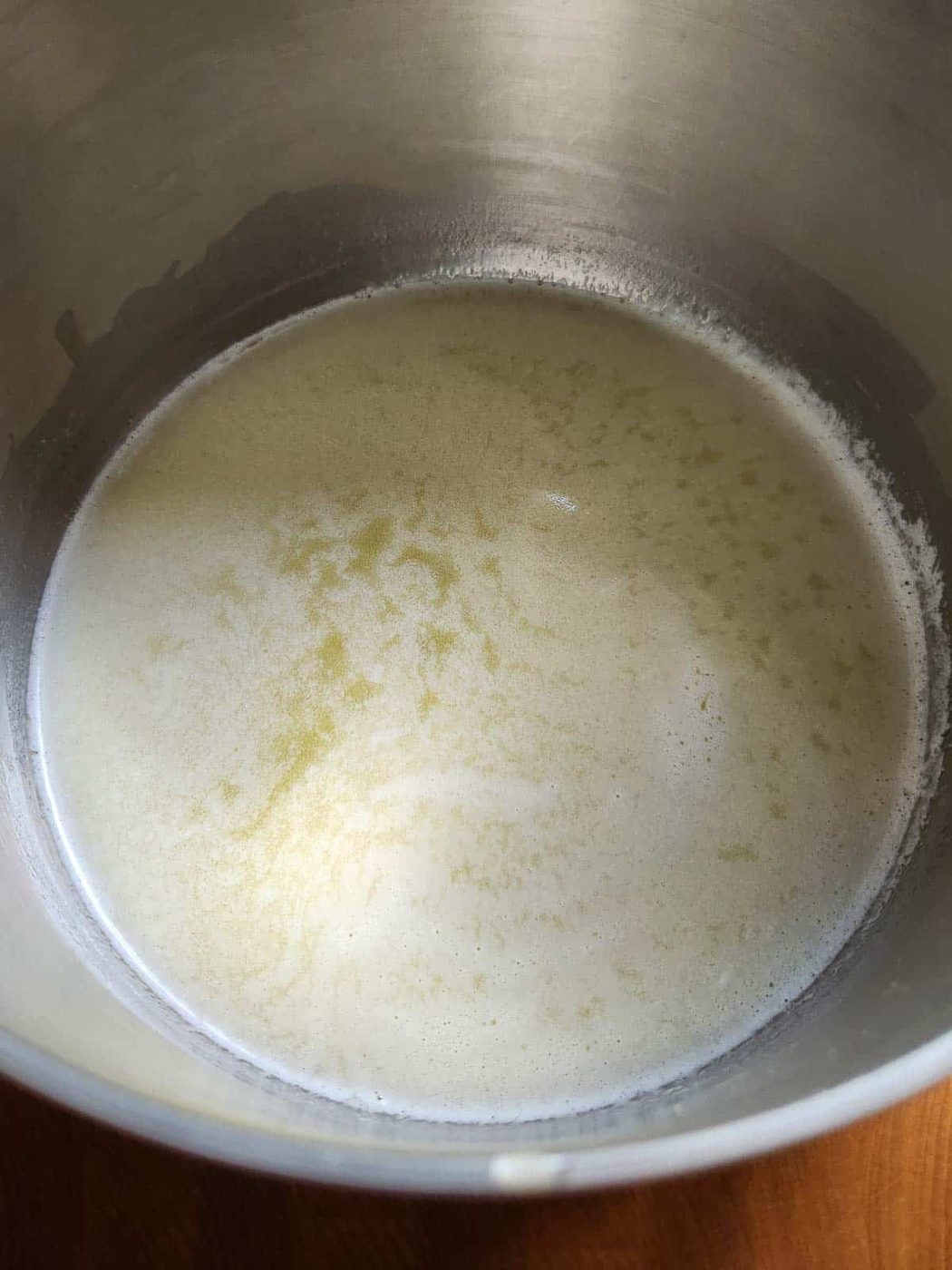 Melted butter in a metal bowl.