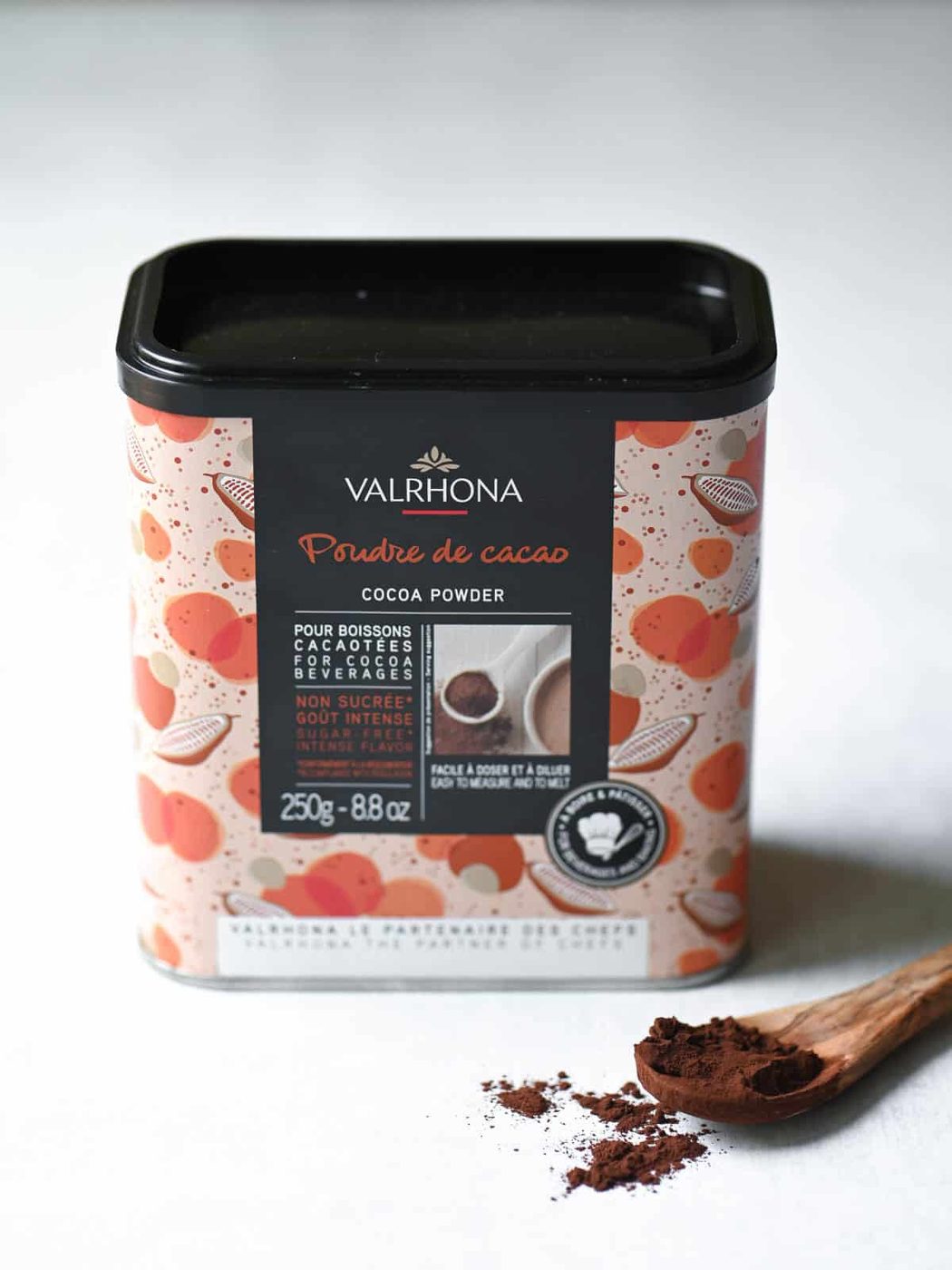 A box of Valrhona cocoa powder on a white surface.