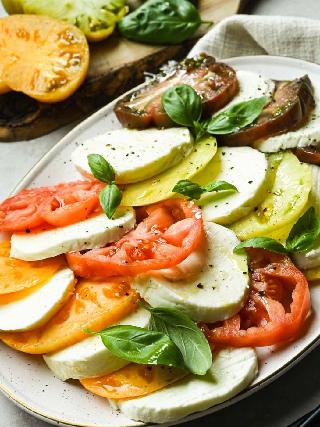 Platter of Caprese salad on a beige plate.
